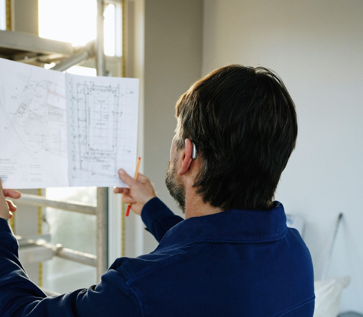 Project lead reviewing building plans on a job site